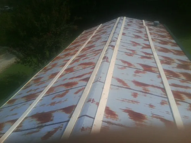 Rusted metal roof panels with new wood purlins before replacement — Storm Damage Roof Repair in Three Rivers by Roofing Brothers